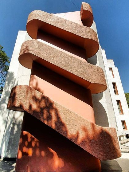 A unique perspective of the sculptural spiral staircase, a central feature of the WeWork building's reconstructed facade.