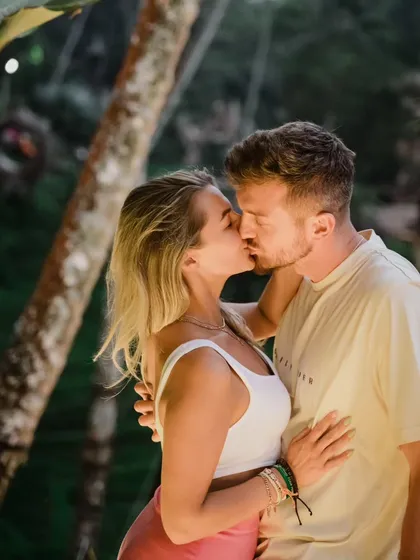 An intimate kiss surrounded by the lush greenery of Bali. This photo from a destination shoot captures the tropical romance and natural beauty of the location.