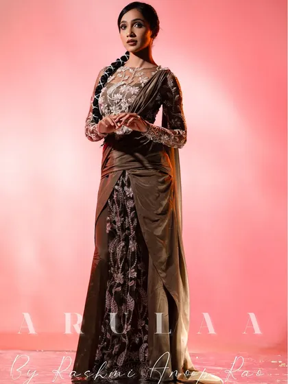 I also love creating modern, Indo-Western outfits. This is a custom draped saree gown with intricate silver floral embroidery on sheer fabric, designed for a unique and elegant reception or red carpet look.