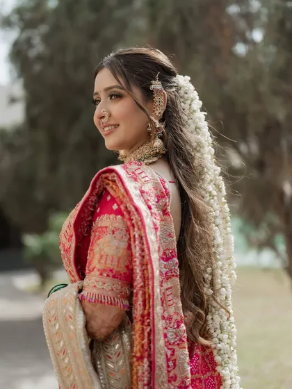 The beauty is in the details. This side profile showcases the intricate floral hairstyle and the delicate ear chain, which are key parts of the complete bridal look I create.