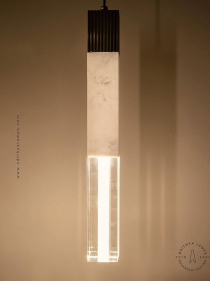 A collection of our pillar pendants, which combine sections of solid marble, fluted metal, and clear crystal. These substantial, high-quality fixtures can be hung individually or in clusters to create a dramatic effect in stairwells or entryways.