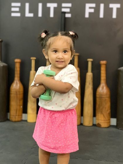 My daughter turned into an anime character with the Ghibli trend, holding a dumbbell in our studio.
