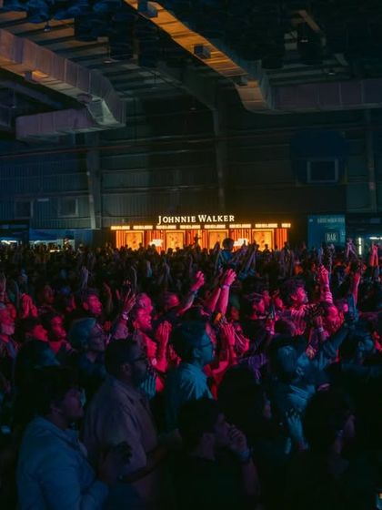 The massive crowd at the Jacob Collier concert, fully immersed in the performance. Our productions are designed to handle huge audiences, with seamless logistics and high-quality amenities like the branded Johnnie Walker bars seen here.