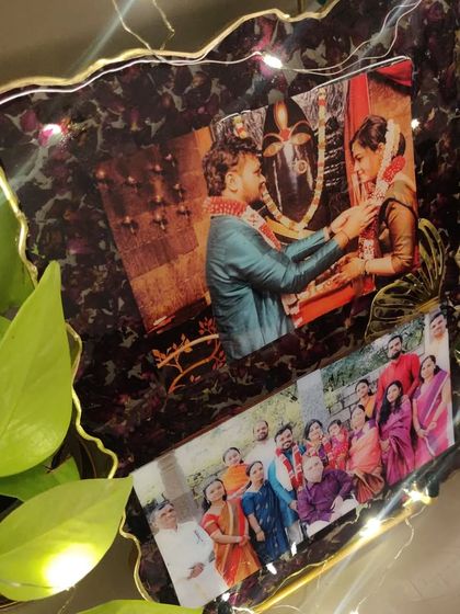 For this custom resin frame, I used the couple's varmala flowers to create a rich, dark border around their favorite wedding and family photos. The added fairy lights make it glow.