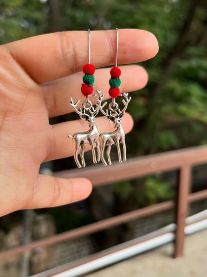 Get into the festive spirit with these reindeer charm earrings. Part of my "earrings under 50/-" collection, they feature red and green beads for a Christmassy feel.