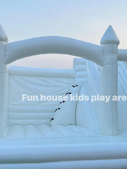 A straight-on view of the white castle's archway, inviting kids to come in and play.
