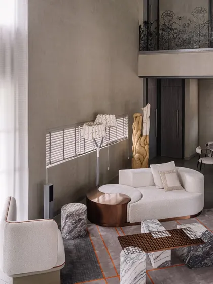 A wider view of the living space, where the sculptural railing on the upper level becomes an integral part of the overall interior design, visible from the main seating area below.