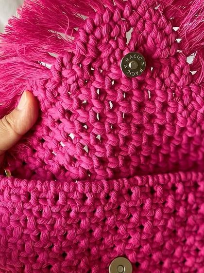 The inside of my sling bag shows the magnetic button I use to keep your things safe. It's small but surprisingly spacious for your phone, keys, and a little notebook.