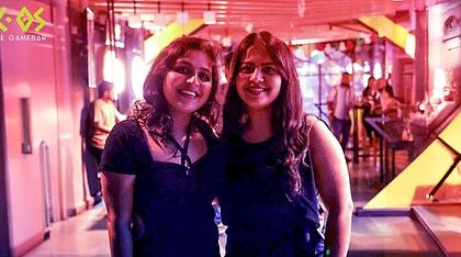 Two friends posing for a photo, capturing the excitement and glamour of our New Year's party.