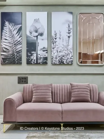 The seating area is anchored by a soft rug and nested coffee tables with marble tops, creating a luxurious yet comfortable feel.