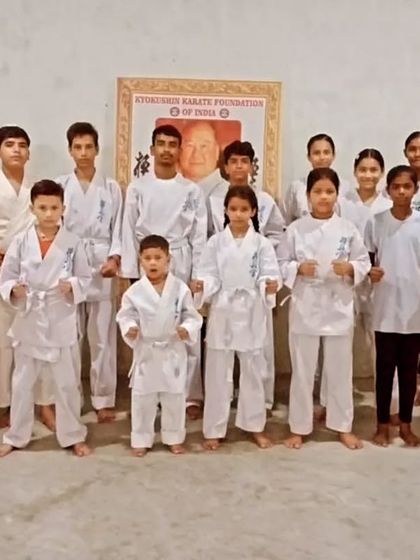 The team posing together in the dojo. The portrait of Sosai Oyama in the background reminds us of our lineage and philosophy.