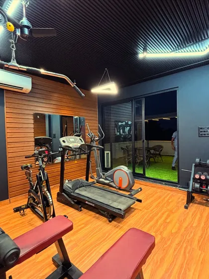 This corner of the gym is dedicated to cardio, with a treadmill and elliptical machine. The large UPVC sliding doors open up to the outdoor lounge, letting in natural light and providing a great view during a workout.