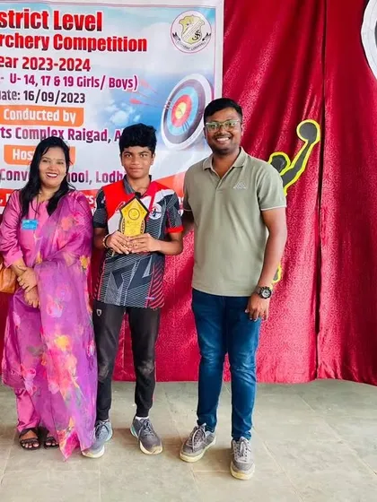 A student and his proud family with me after his gold medal win at the district level competition. Support from both coach and family is crucial for success.