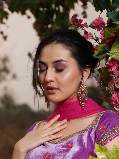 A serene portrait of the model in the lavender velvet lehenga, complemented by the soft pink tulle dupatta. An enchanting look for an evening celebration.