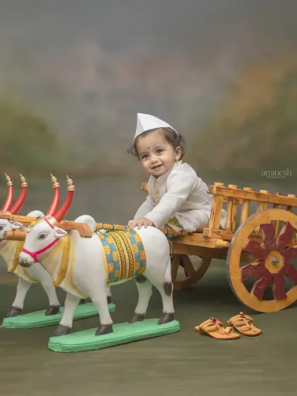 Another variation of the bullock cart theme, this time with the baby wearing a traditional white cap. His happy expression shows how comfortable and fun my studio sessions are for kids.