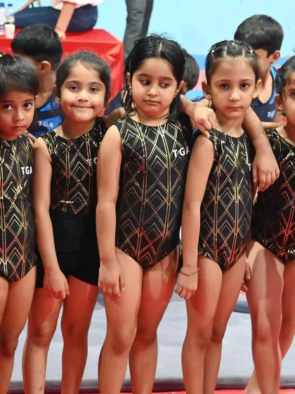 A team of friends. These girls are ready to take on their gymnastics class together.