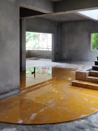An early stage of construction, with the yellow oxide flooring just being laid. This image shows the raw beauty of the materials before the final finishes are applied.