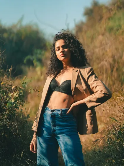 For this outdoor editorial, we blended sharp fashion with a raw, natural landscape. The golden hour light and the model's strong pose against the wild backdrop create a feeling of untamed confidence.