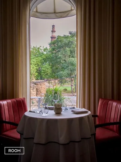 I offer intimate tables with a window to history. This particular spot frames the Qutub Minar perfectly, offering a private and picturesque dining experience.