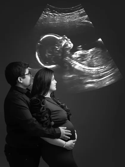 Sometimes, the most powerful stories are told in whispers. Using a projection of their baby's sonogram, we created this deeply personal and emotional black and white portrait, a first family photo before they even meet.