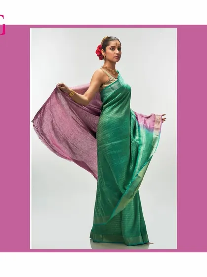 Another dynamic shot of the green and purple silk linen saree, highlighting its fluid drape and the unique patina effect of the fabric.