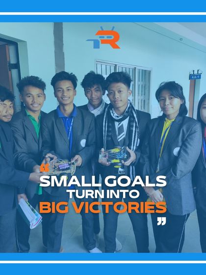 A group of students proudly holds up their completed robot projects, showcasing their success and the tangible results of our workshops.