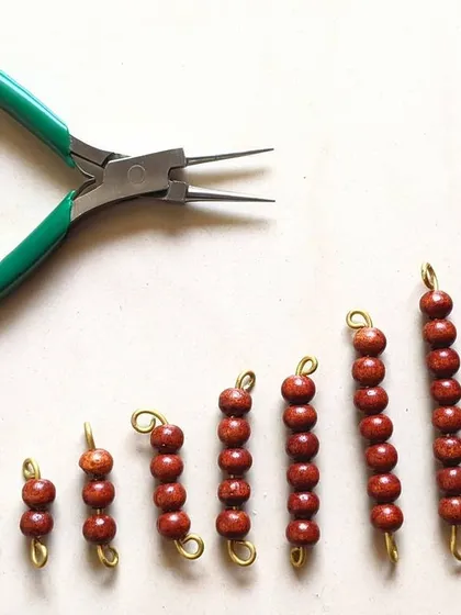 This image captures the story of how observation turns into creation. A young boy, after watching his mother make Montessori materials, decided to create his own set of bead bars late one night. It’s a powerful reminder that learning isn't scheduled; it's a spark that we must be ready to nurture whenever it appears.