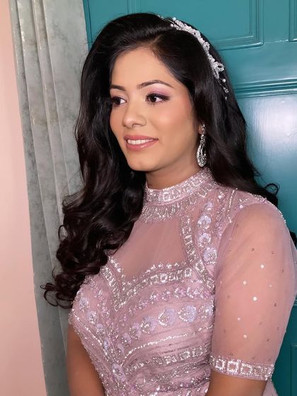 Neha looking absolutely lovely for her engagement. The soft waves, delicate hairband, and pink-toned makeup create a look that is pure romance.