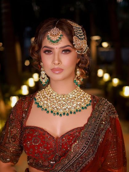 Channeling royal vibes with a touch of realness. This look, with its rich red lehenga and intricate jewelry, is crafted for the modern queen.