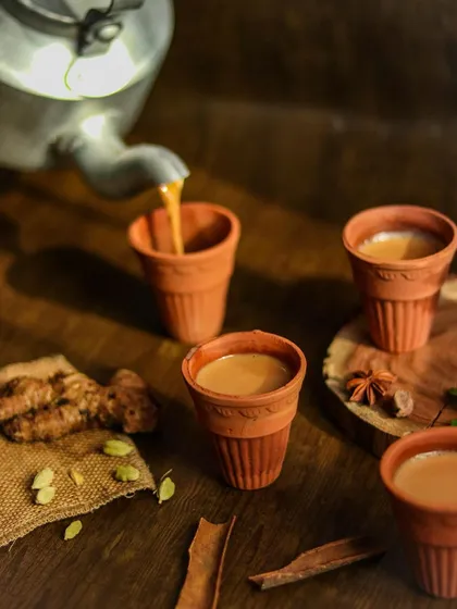Capturing the action of chai being poured into earthen kulhads. The motion adds life to the image, making it feel warm and inviting.