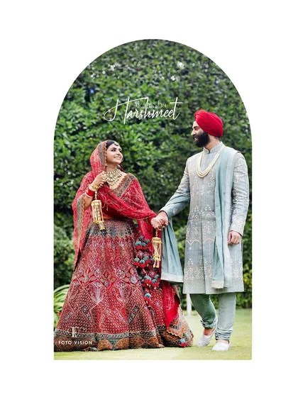 A regal portrait of a Sikh couple on their wedding day, showcasing the elegance of their traditional attire against a lush green backdrop. We have a deep understanding and respect for the customs of Anand Karaj ceremonies.