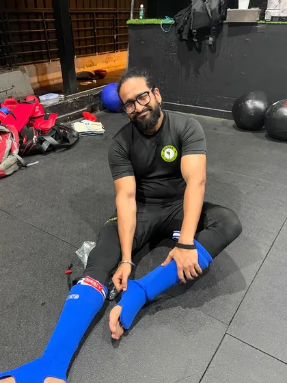 The hard slog of taking off your kit after sparring. It's a shared experience that builds camaraderie after a tough session.