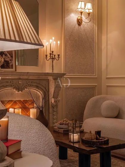 The interplay of light and shadow in this candlelit lounge. The design uses multiple light sources at different heights to create a layered, dynamic, and warm environment.