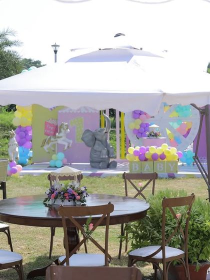 A wide view of an outdoor carnival setup, showing the main stage area under a large white tent. This demonstrates how I can create a fully themed environment in an open lawn space.