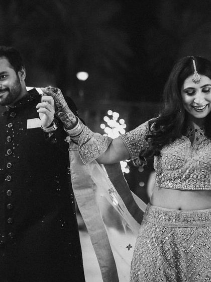 A black and white shot capturing the energy of a couple's dance with sparklers. These are the epic moments we help create.