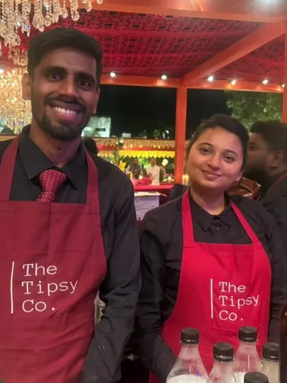 Two of our team members, a male and female bartender, ready to serve at a wedding. Our diverse team is ready to handle events of any scale.