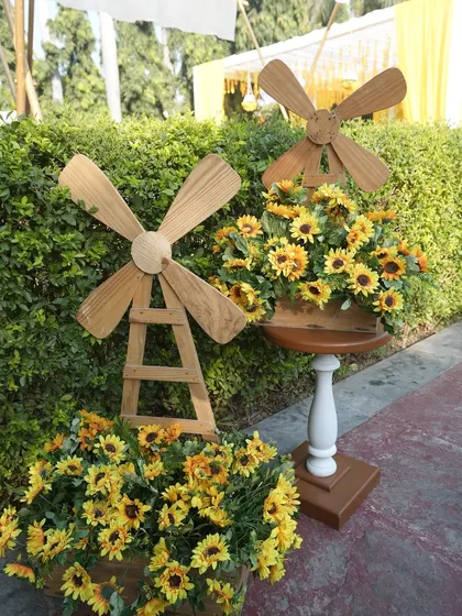 Quirky and charming details like these wooden windmills filled with sunflowers add a playful touch to the Haldi decor. I believe in adding elements that surprise and delight guests.