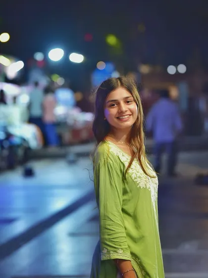 A beautiful smiling portrait with a stunning bokeh background. The way the lights blur into colorful circles is what makes night photography so magical.