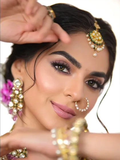 A close-up shot focusing on the eyes and flawless skin. This look demonstrates classic, long-wear elegance with a perfectly blended eyeshadow and a soft, matte lip.