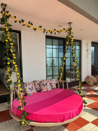 For this Mehendi, I installed a large circular swing decorated with yellow marigold garlands. It serves as a comfortable and stylish seating option for the bride.