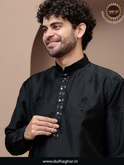 Wear the royalty in fabric. A close-up of a model in a black kurta with subtle embroidery and a detailed placket.