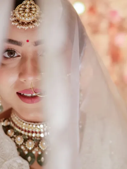 A bride's glance through her veil holds so much emotion. We focus on capturing these delicate, intimate bridal portraits that reveal her personality and the beauty of the moment.