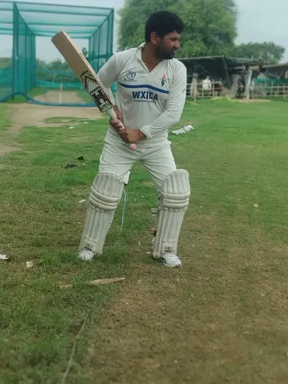 A batsman ready at the crease, showcasing a solid stance and balance. Getting this starting position right is the foundation of every good shot.