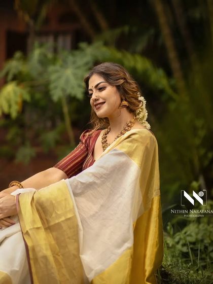 Another beautiful shot from the Onam series with Anusree. The classic Kerala saree is draped to perfection against a lush, natural backdrop.