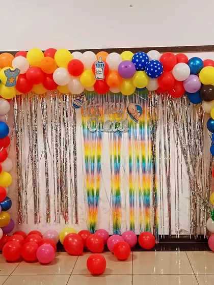 A colorful balloon arch and backdrop for a "Chatti" ceremony, a traditional celebration for a 12-day-old newborn.