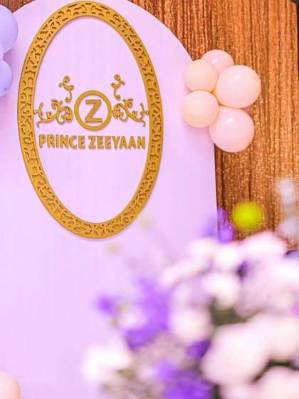 A close-up of the "Prince Zeeyan" insignia in a golden frame on a soft lavender backdrop. This personalized detail adds a touch of custom elegance to the decor.