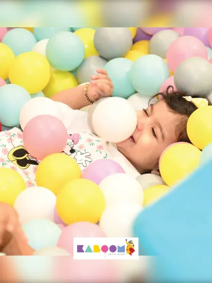 Pure bliss! This little one is having a wonderful time relaxing and playing among hundreds of soft, colorful balls.