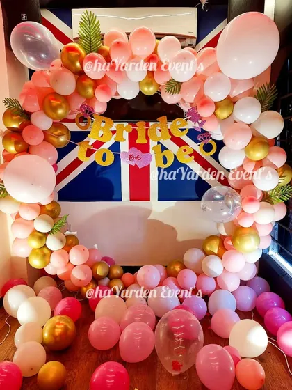 A fun 'Bride to Be' party with a balloon ring in front of a Union Jack flag, showing how I can incorporate unique elements into the decor.