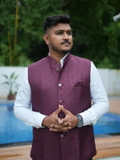 The wine-colored waistcoat can be paired with different colored shirts to create multiple looks. It's a smart and affordable rental option.