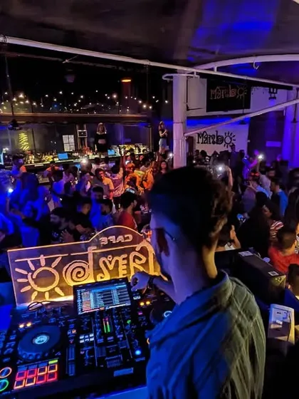 A view from behind my shoulder, looking out at a sea of people with their phone lights on at Cafe Mambo. It's moments like these that show the power of music to unite people.